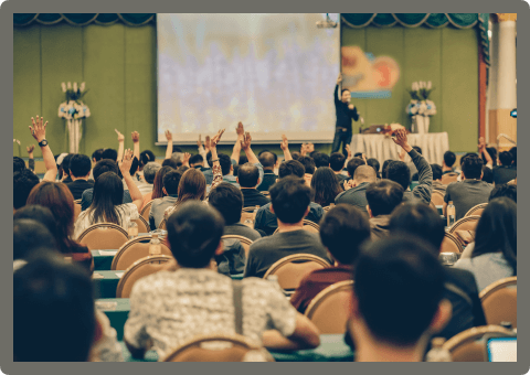 rear-view-of-audience-showing-hand-to-answer-the-q-5LMGUPR.png